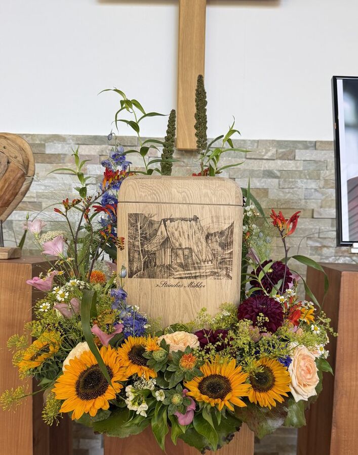 Blumengesteck mit Sonnenblumen und Kreuz